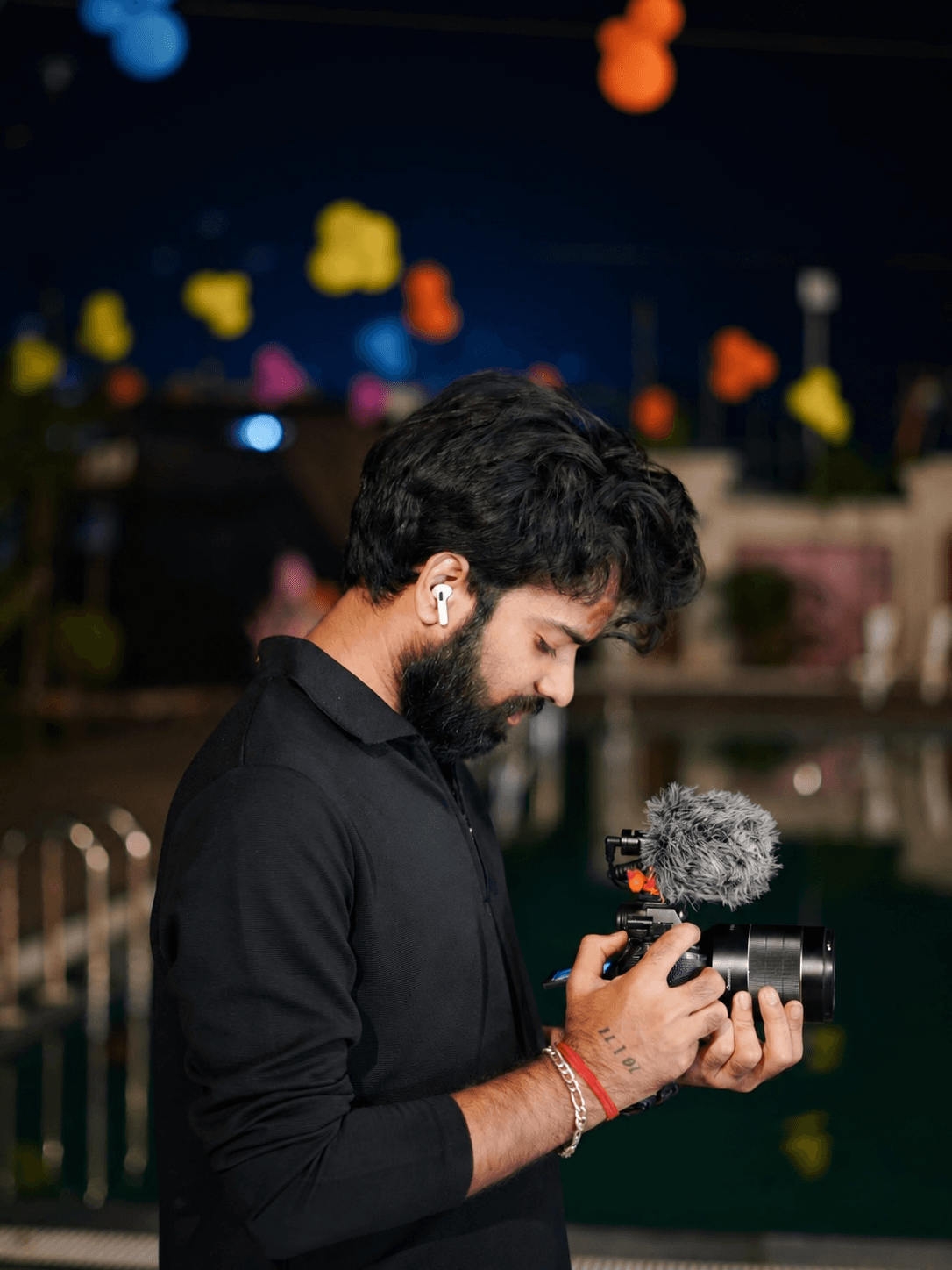 Pratik Singh reviewing footage with a camera