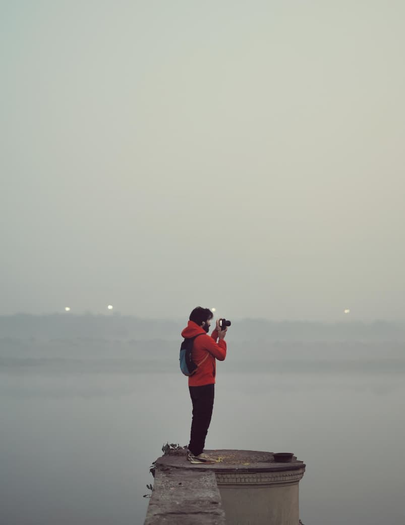 Pratik Singh photographing by the water